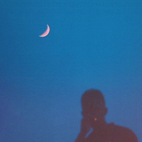 Silhouette of a person meditating with a calm expression.